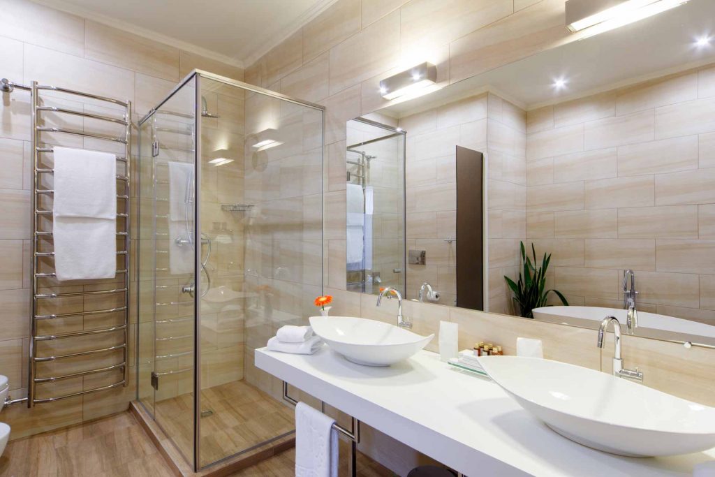 Modern hotel bathroom with white quartz countertops