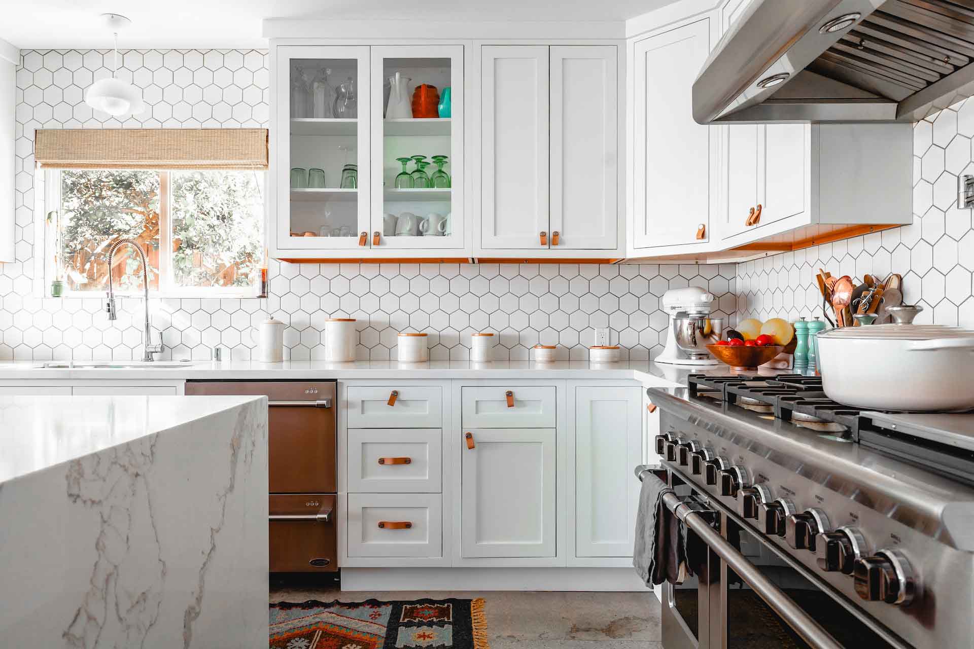 Newly remodeled kitchen with white quartz countertops and honeycomb tile backsplash