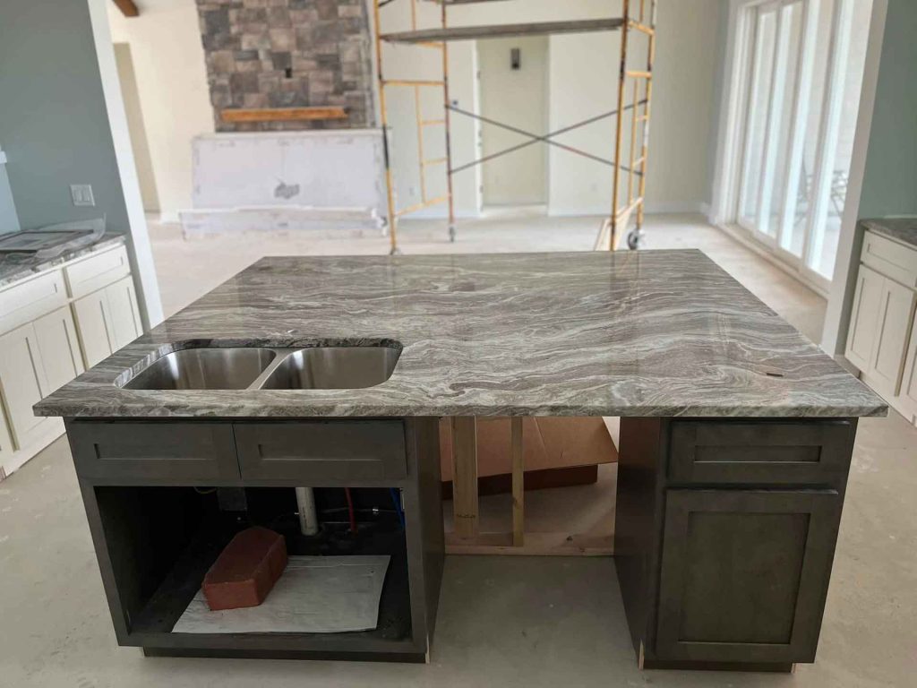 Progress photo of kitchen island with sink and quart countertop being built